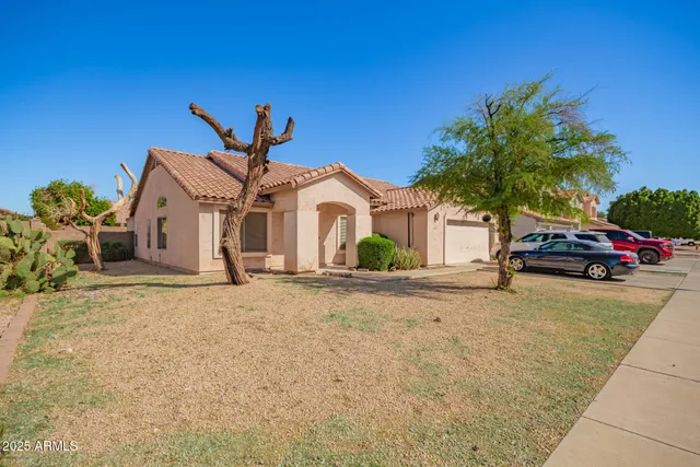a view of a house with a yard and garage