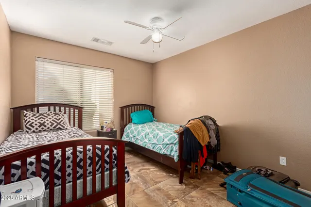 a bedroom with furniture and a window