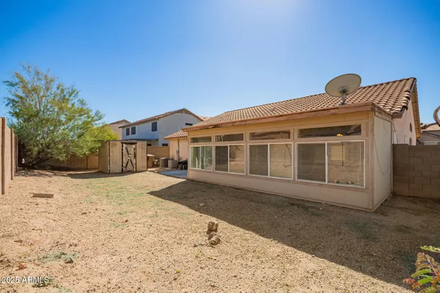 a view of a house with a backyard