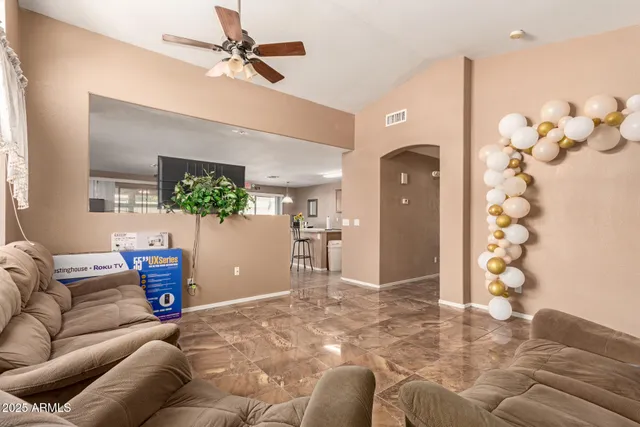 a living room with furniture and a chandelier