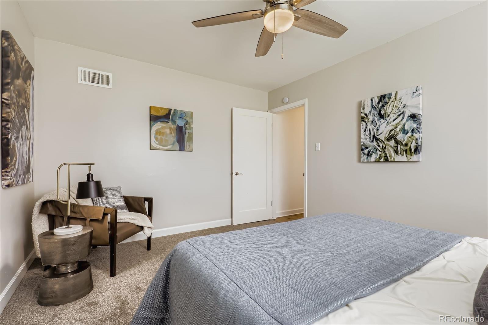 3600 East 30th Avenue Denver, CO 80205 - Photo 16 of 29 a bedroom with a bed and a chandelier