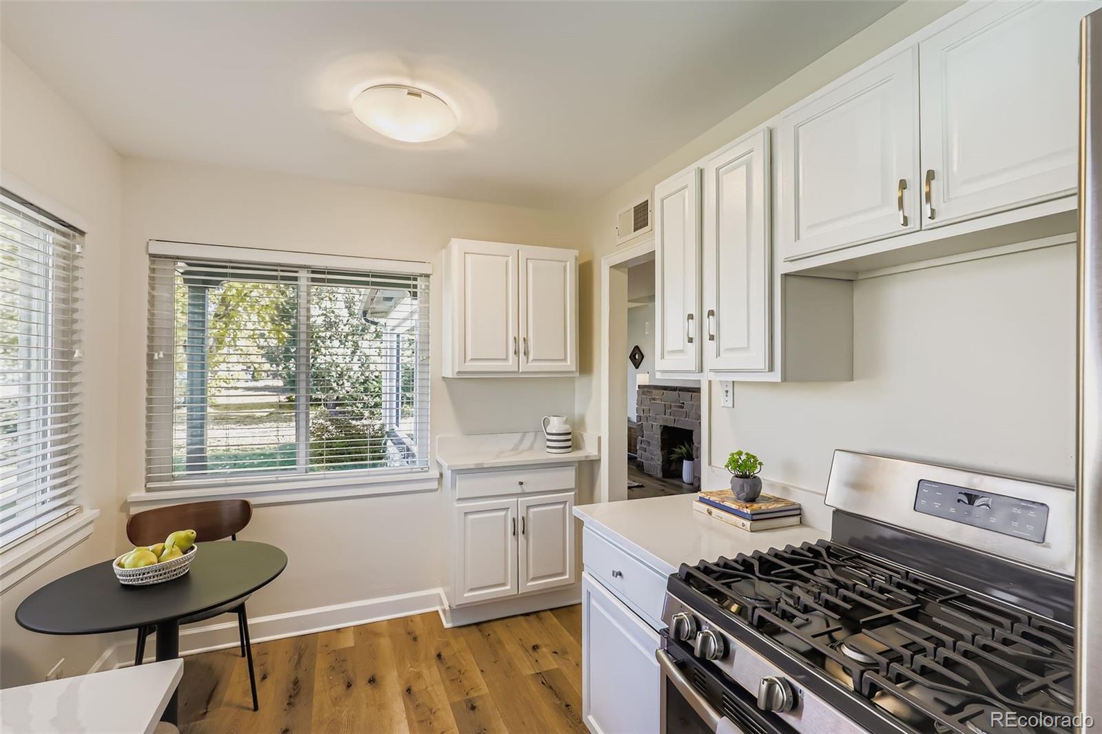 3600 East 30th Avenue Denver, CO 80205 - Photo 9 of 29 a kitchen with stainless steel appliances a stove a sink cabinets and a window