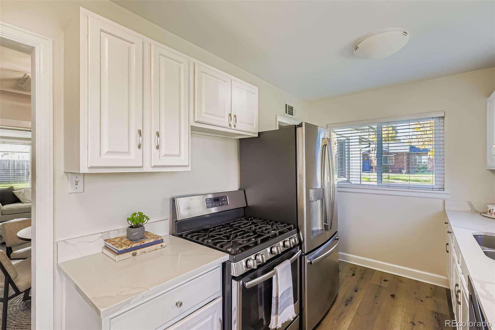 3600 East 30th Avenue Denver, CO 80205 - Photo 10 of 29 a kitchen with a stove and a refrigerator