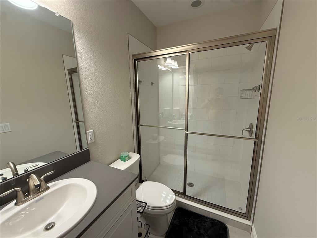 10958 Rustic Timber Loop San Antonio, FL 33576 - Photo 25 of 48 a bathroom with a sink toilet and shower
