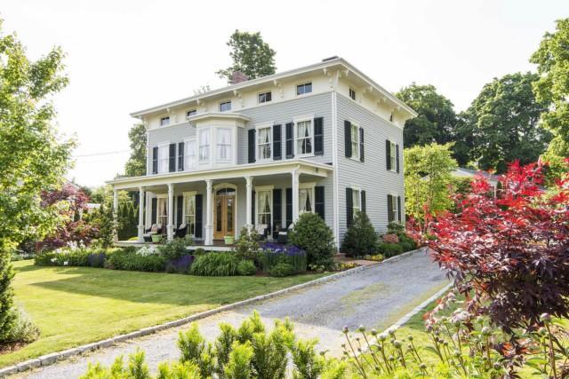 a front view of a house with garden