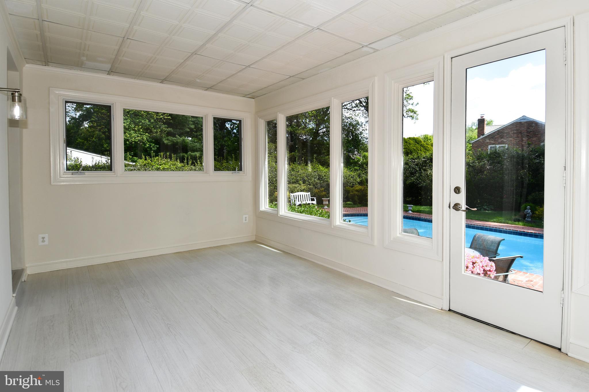 7109 Radnor Road Bethesda, MD 20817 - Photo 20 of 82 SUNROOM VIEW OF EXTERIOR REAR POOL AND YARD