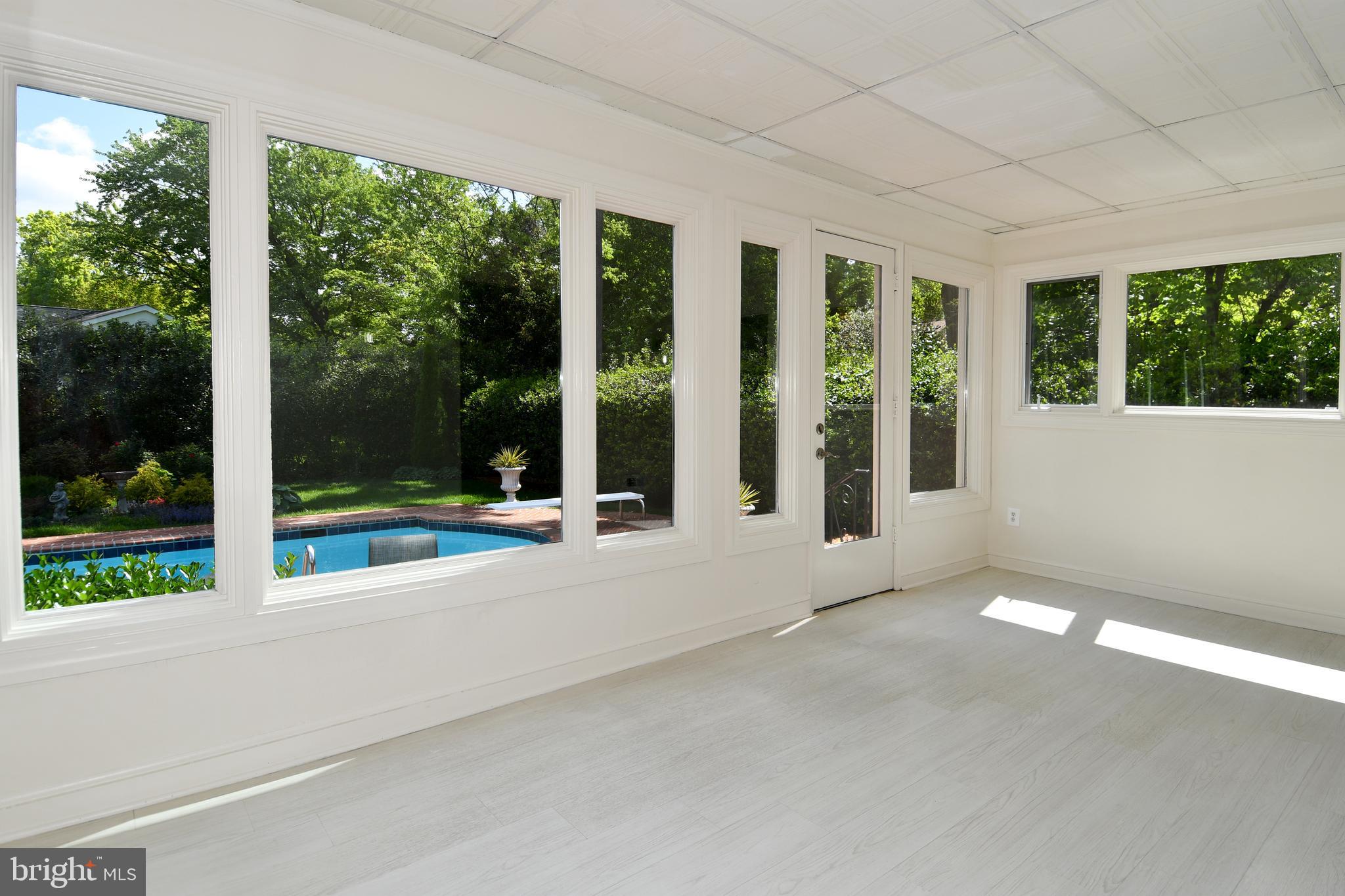 7109 Radnor Road Bethesda, MD 20817 - Photo 21 of 82 SUNROOM WALL OF WINDOWS BRING IN NATURAL SUNLIGHT