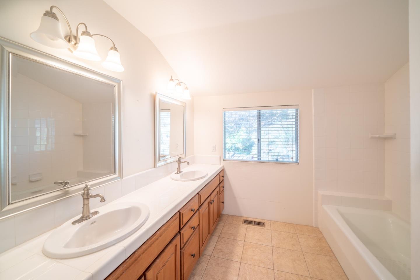 1553 Meadow Lane Mountain View, CA 94040 - Photo 15 of 28 a bathroom with a double vanity sink a mirror and a bathtub