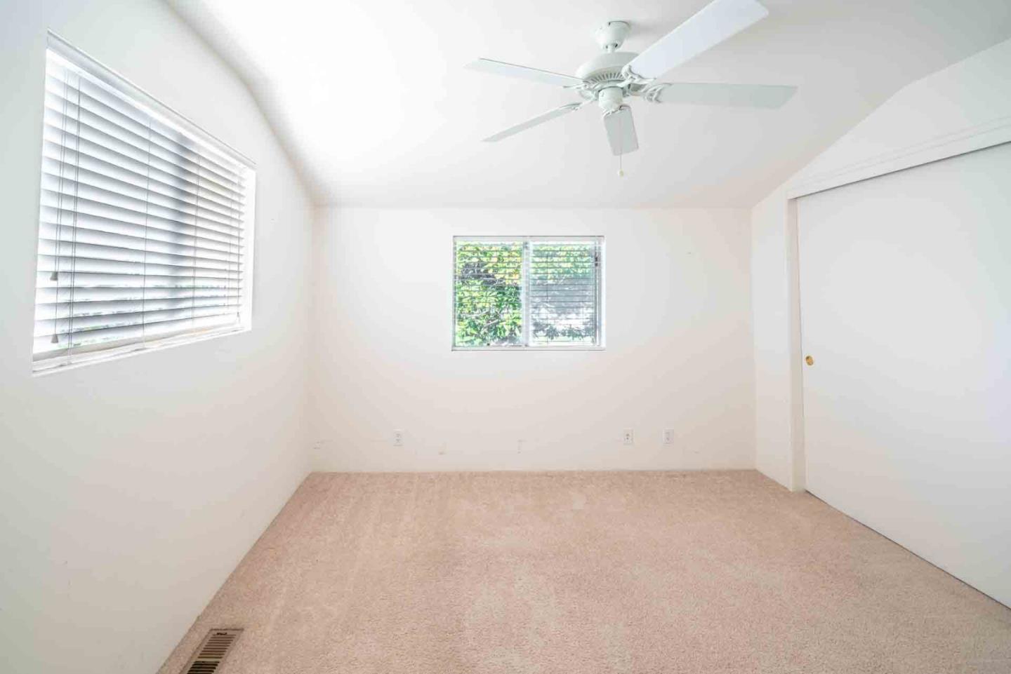 1553 Meadow Lane Mountain View, CA 94040 - Photo 19 of 28 an empty room with windows and fan