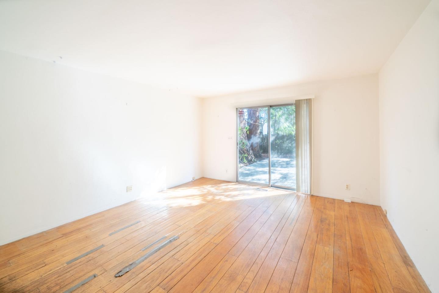 1553 Meadow Lane Mountain View, CA 94040 - Photo 20 of 28 a view of an empty room with wooden floor and a window