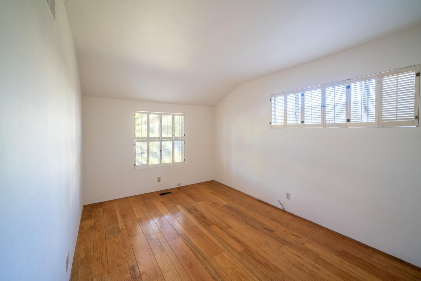 1553 Meadow Lane Mountain View, CA 94040 - Photo 24 of 28 an empty room with wooden floor and windows