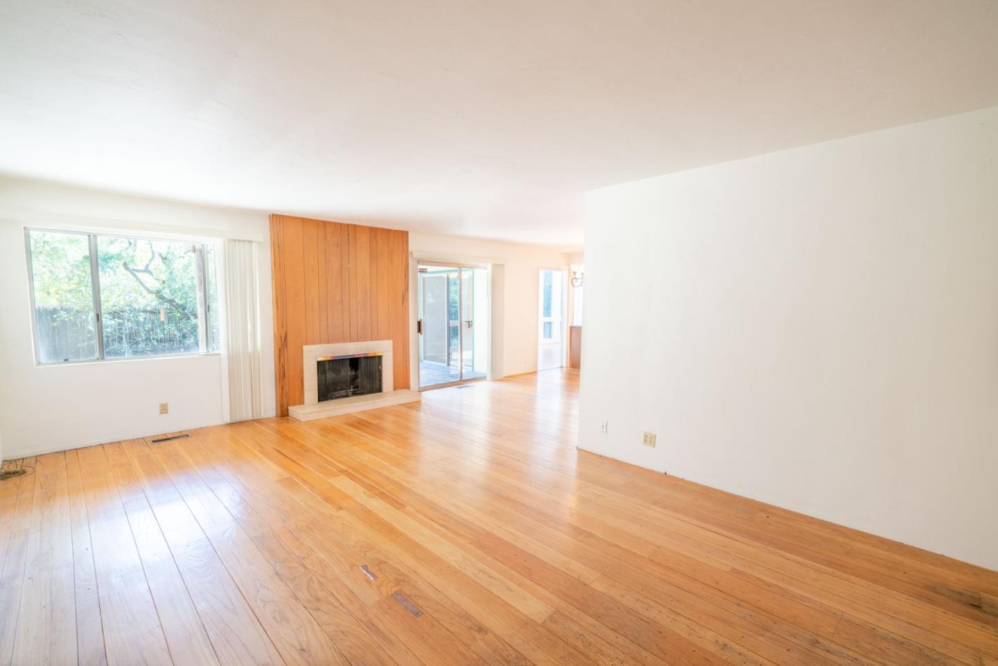 1553 Meadow Lane Mountain View, CA 94040 - Photo 7 of 28 an empty room with wooden floor and windows