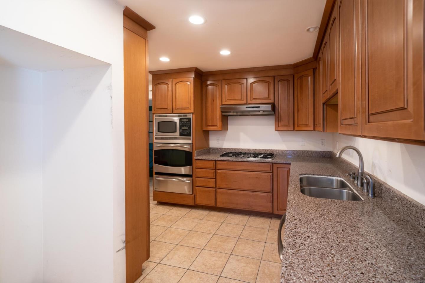 1553 Meadow Lane Mountain View, CA 94040 - Photo 9 of 28 a kitchen with stainless steel appliances granite countertop a sink and cabinets