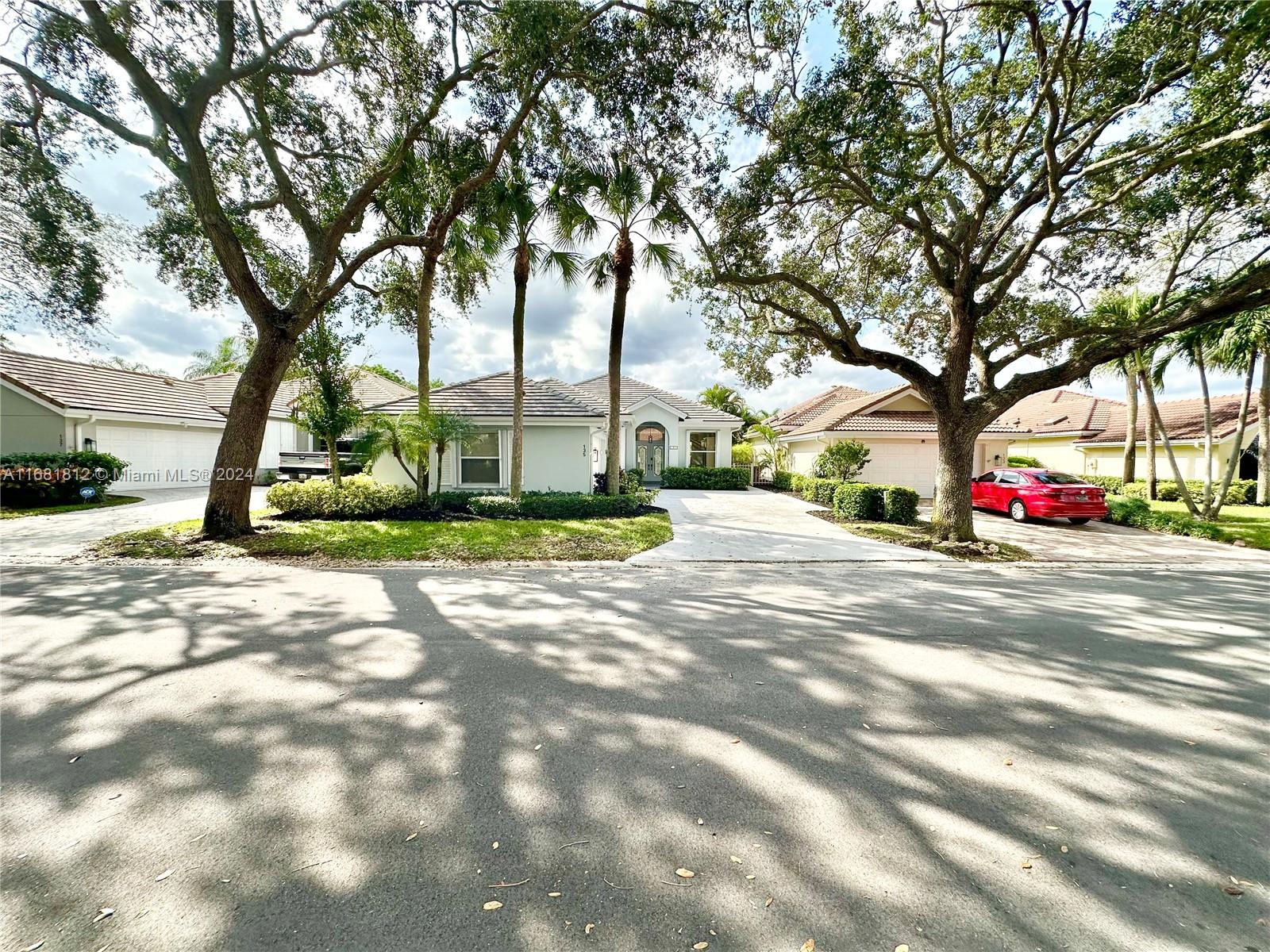 135 Hampton Circle Jupiter, FL 33458 - Photo 1 of 39 EXTERIOR LINED WITH LOVELY OAK TREES