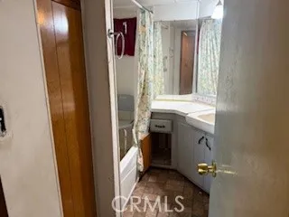 a bathroom with a sink and mirror with toilet