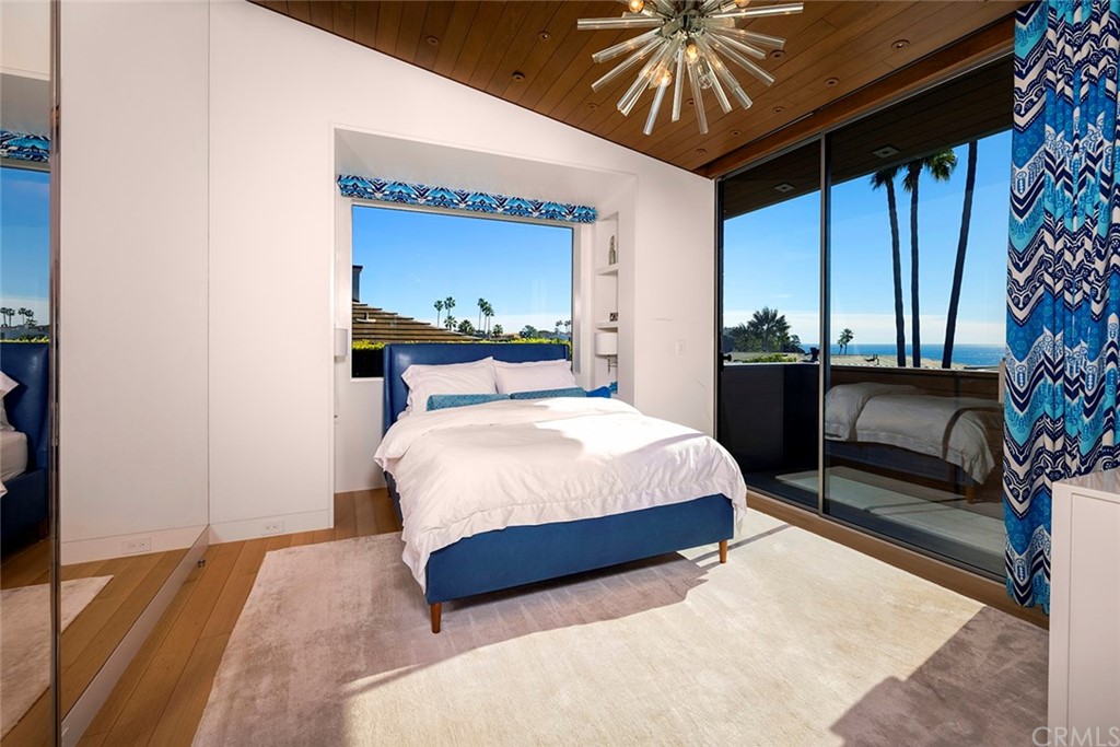 2538 Monaco Drive Laguna Beach, CA 92651 - Photo 17 of 26 a bedroom with a bed and a chandelier