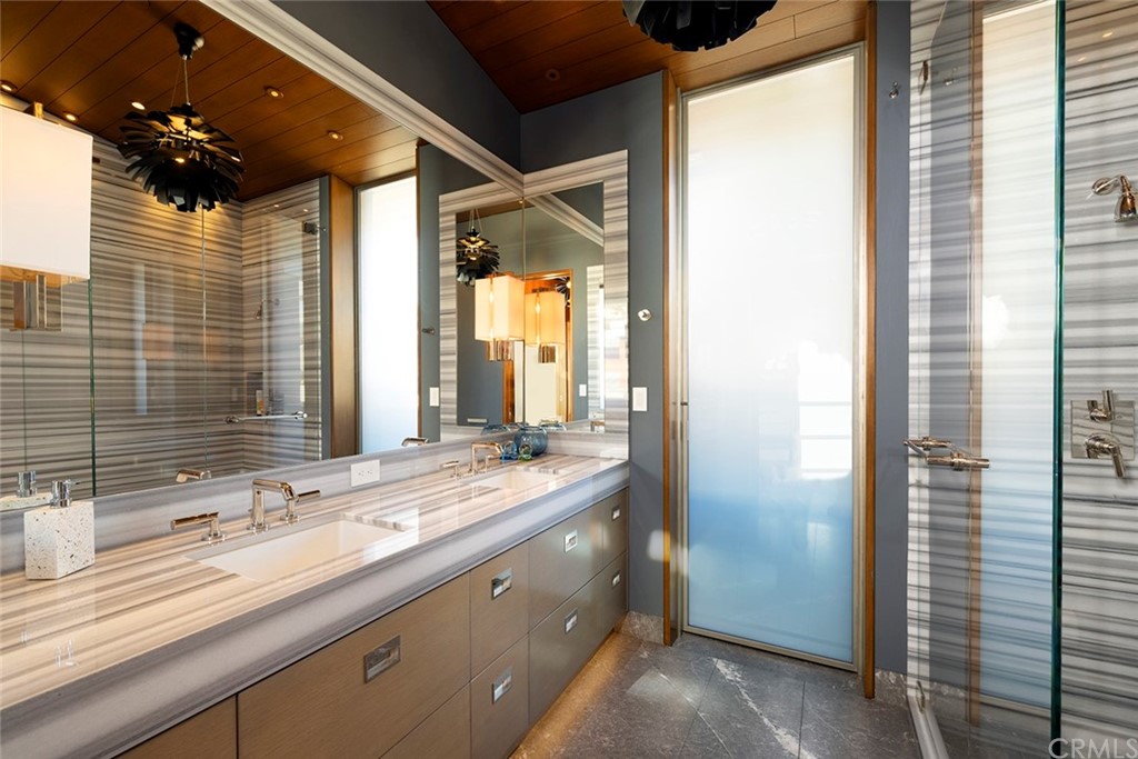 2538 Monaco Drive Laguna Beach, CA 92651 - Photo 20 of 26 a bathroom with a double vanity sink and a mirror