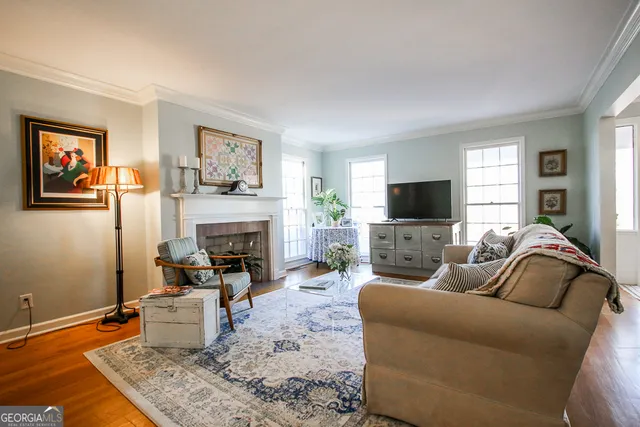 a living room with furniture and a fireplace