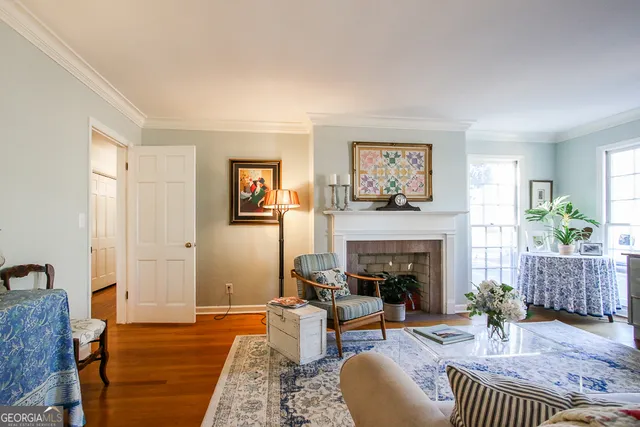 a living room with furniture wooden floor and a lamp