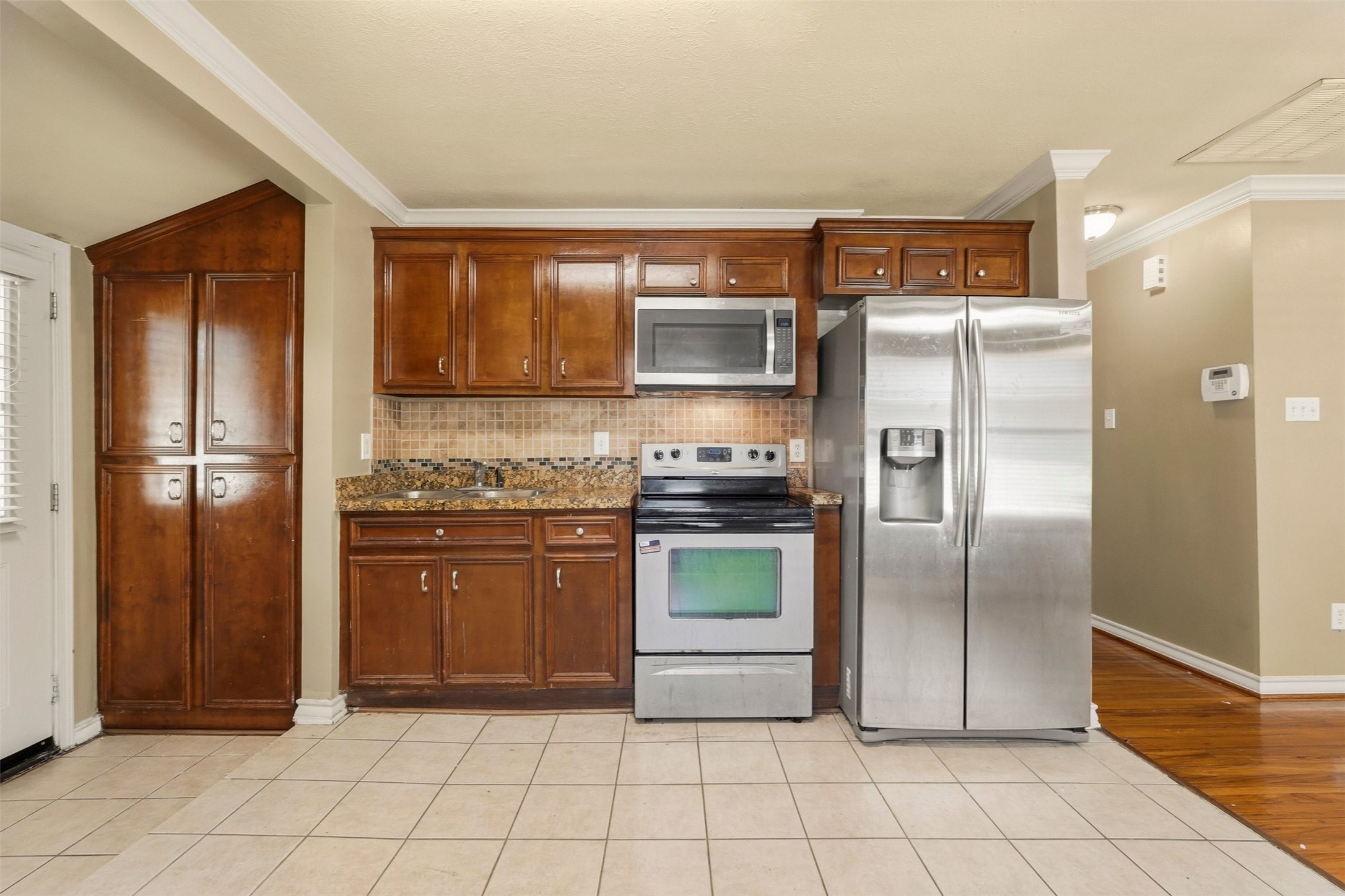 3445 Nathaniel Brown Street Houston, TX 77021 - Photo 10 of 19 a kitchen with granite countertop a refrigerator and a stove top oven