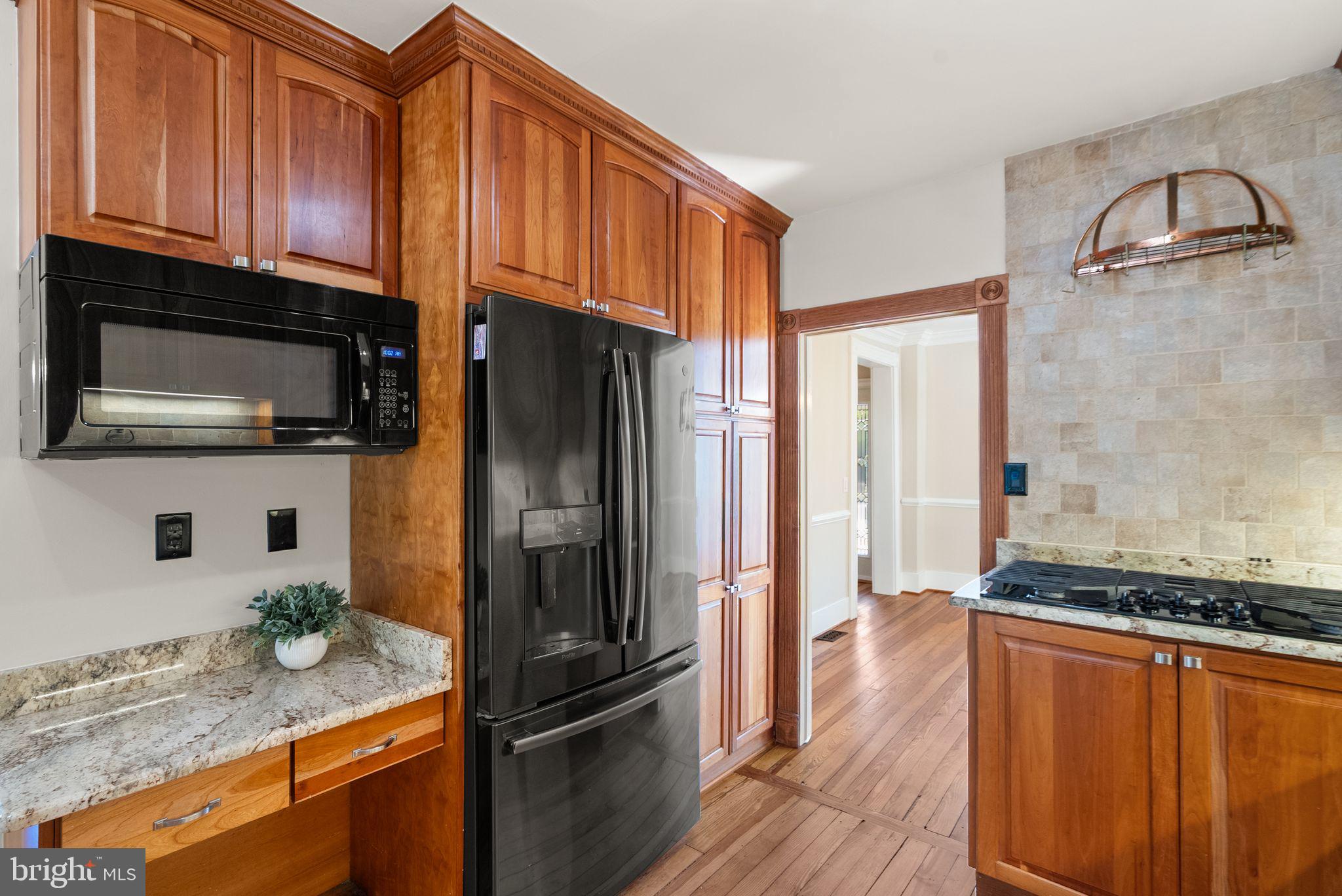 37151 Branchriver Road Purcellville, VA 20132 - Photo 22 of 63 a kitchen with granite countertop a refrigerator stove and microwave