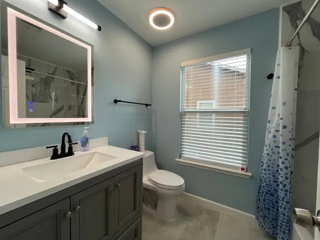 a bathroom with a bathtub and shower