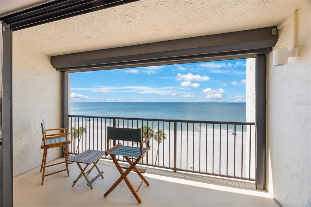 14950 Gulf Boulevard, Unit 605 Madeira Beach, FL 33708 - Photo 1 of 1 a view of a two chairs in the porch