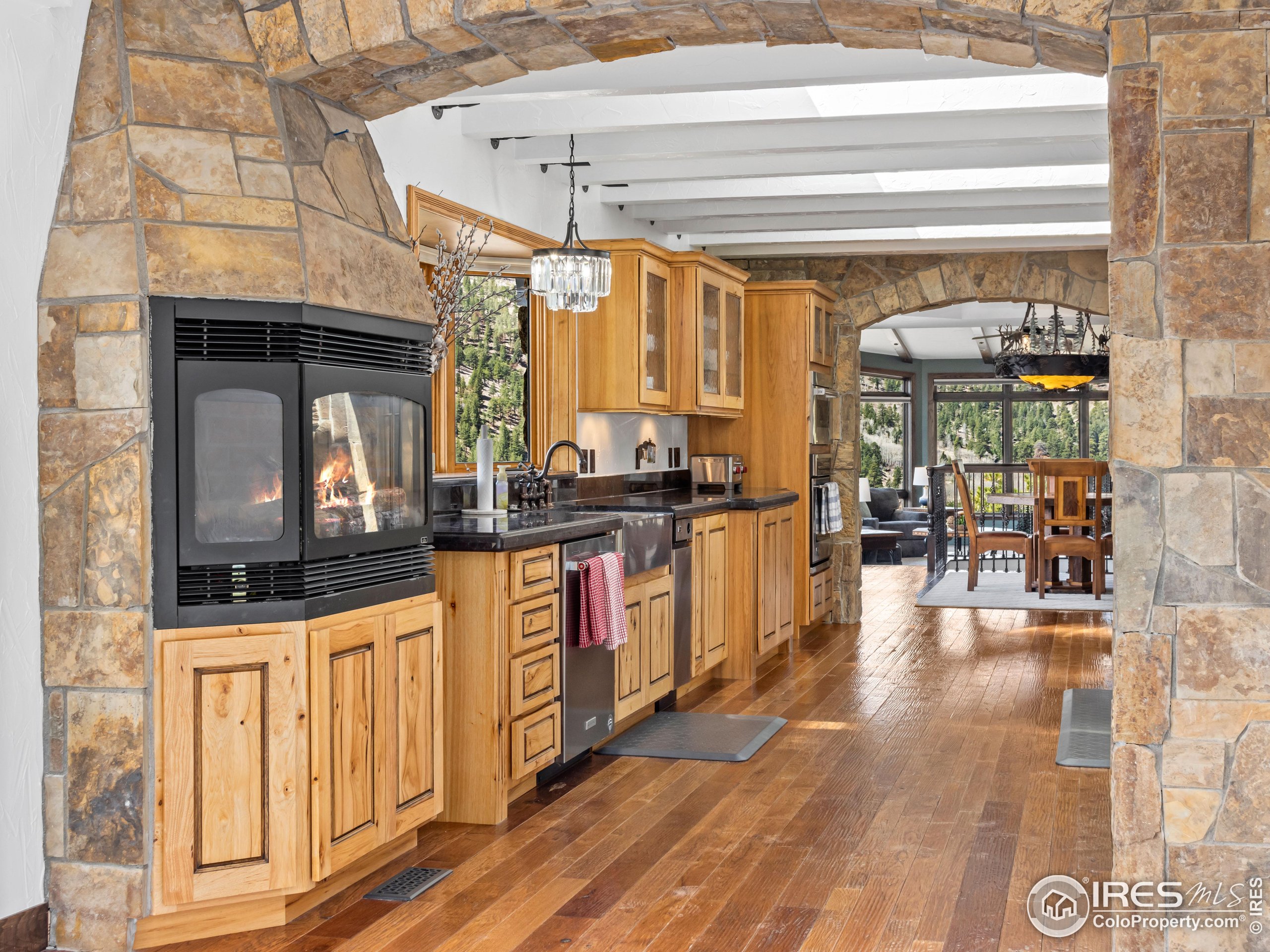 2701 Fall River Road Estes Park, CO 80517 - Photo 13 of 40 a kitchen with stainless steel appliances granite countertop a stove and cabinets with wooden floor