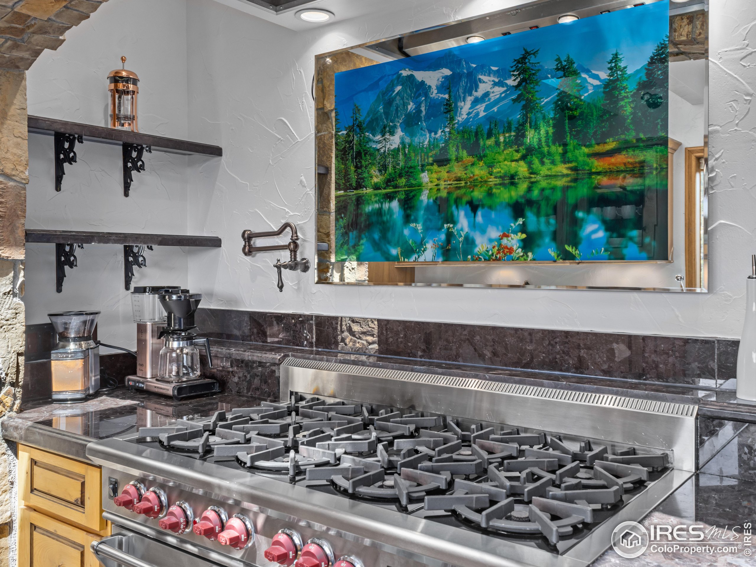 2701 Fall River Road Estes Park, CO 80517 - Photo 14 of 40 a kitchen with a stove a sink and a counter top space