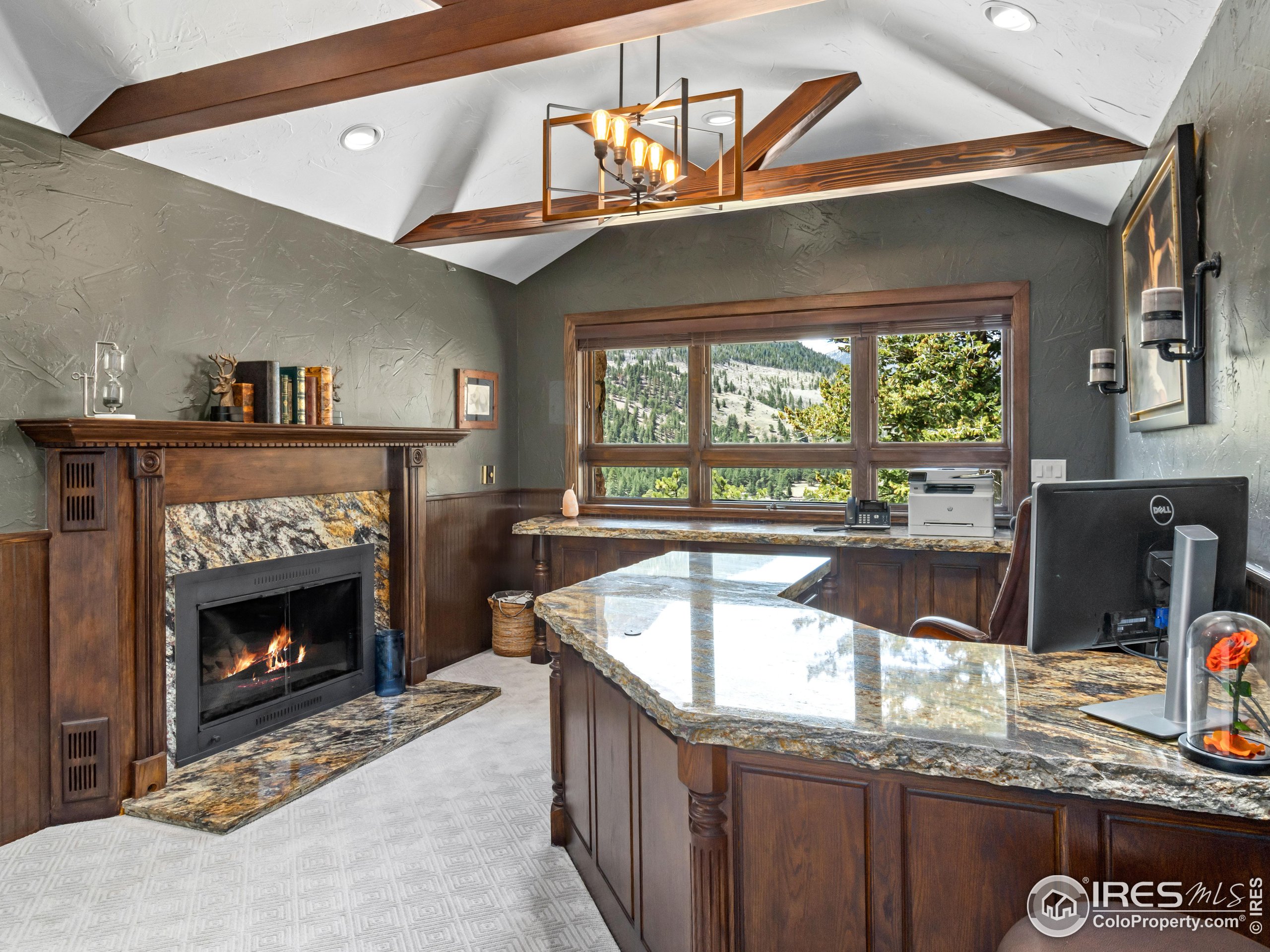 2701 Fall River Road Estes Park, CO 80517 - Photo 26 of 40 a kitchen with a sink a counter top space and a fireplace