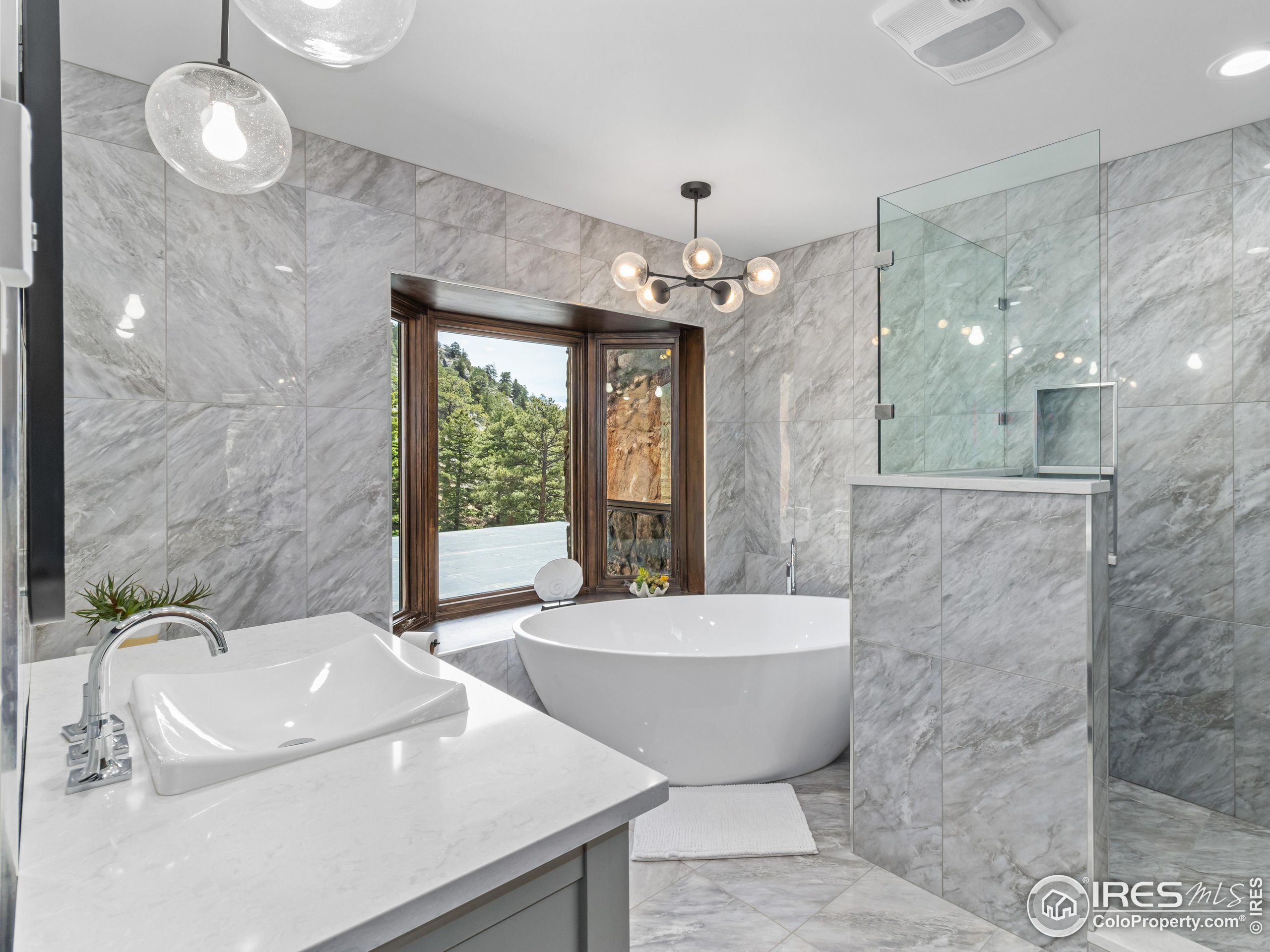 2701 Fall River Road Estes Park, CO 80517 - Photo 28 of 40 a bathroom with a bathtub and sink