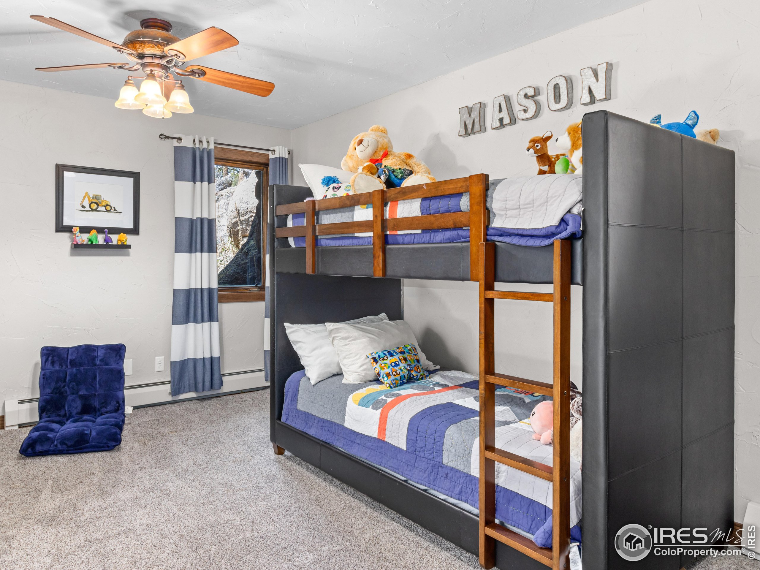 2701 Fall River Road Estes Park, CO 80517 - Photo 29 of 40 a bedroom with a bed and a chandelier