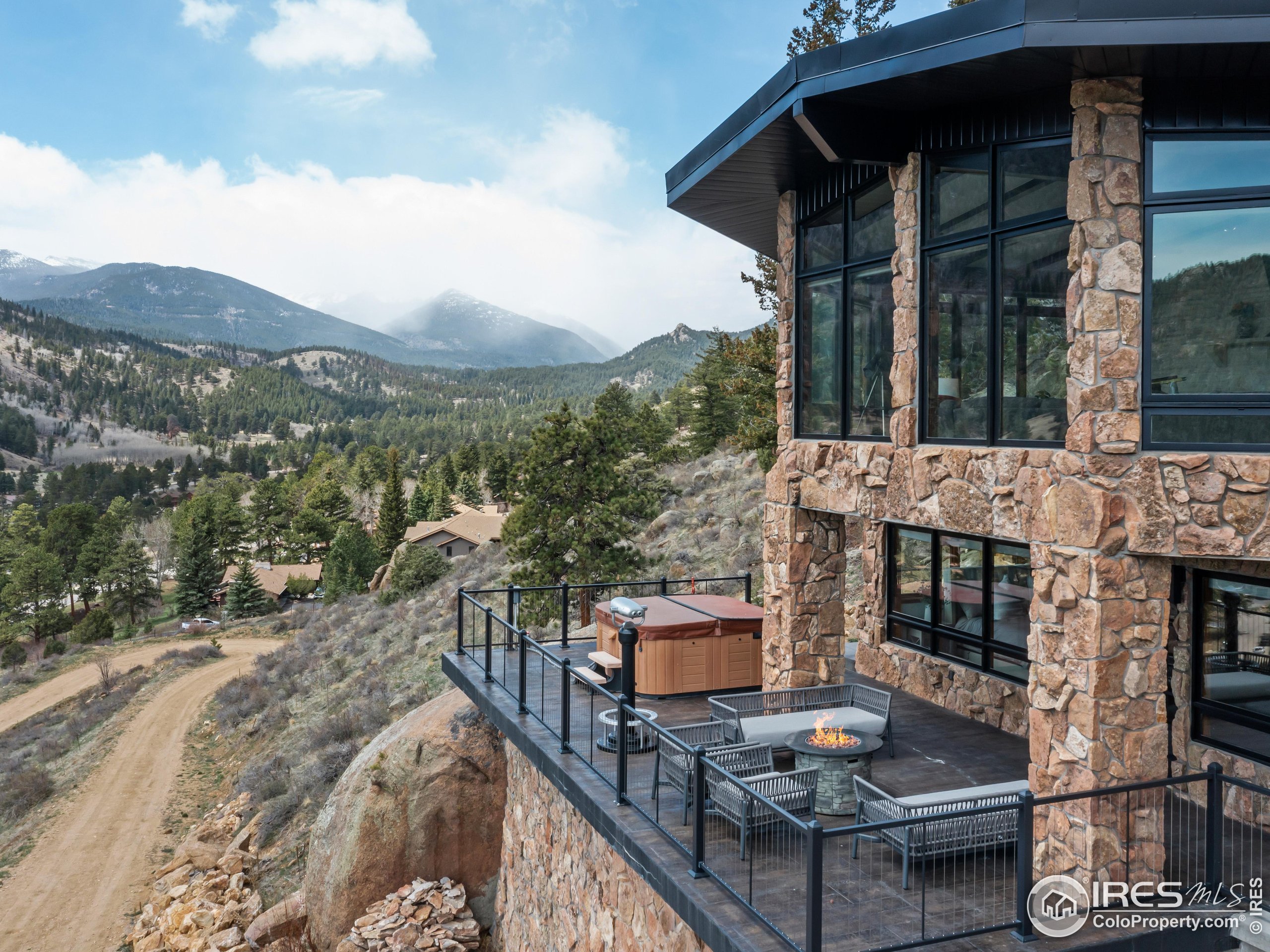 2701 Fall River Road Estes Park, CO 80517 - Photo 32 of 40 a view of a patio with couches table and chairs with wooden floor and fence