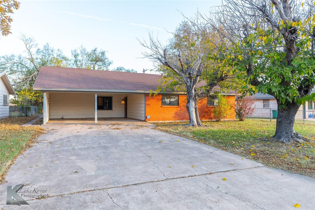 a view of a house with a tree and a yard