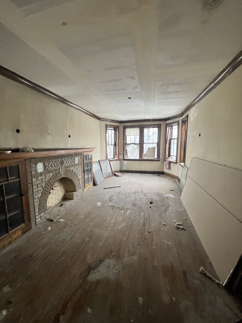 3827 West Fillmore Street Chicago, IL 60624 - Photo 16 of 23 a view of empty room with fireplace and windows