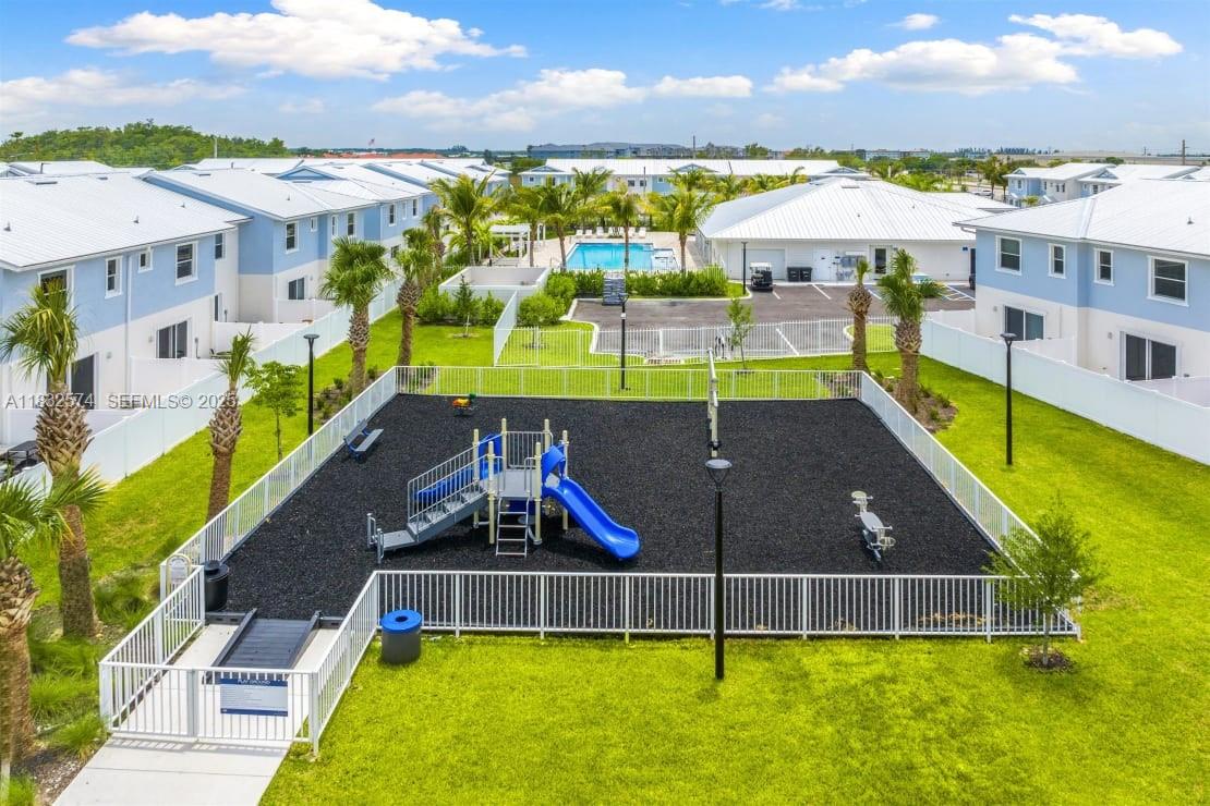 3645 Blue Fin Way, Unit 101 Fort Myers, FL 33916 - Photo 6 of 8 a view of a swimming pool with a patio and a yard