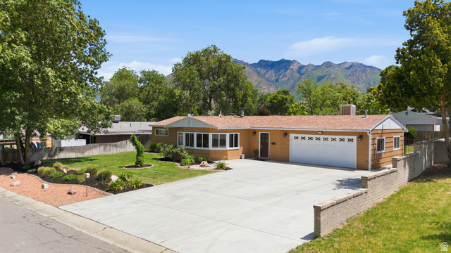 6889 South Village Road Salt Lake City, UT 84121 - Photo 37 of 44 Ranch-style residence featuring a prominent two-car garage and RV hookup area with sewer cleanout