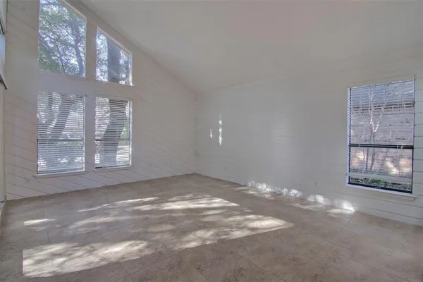 a view of empty room with a fireplace