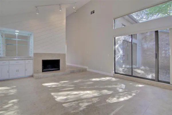 an empty room with windows and closet