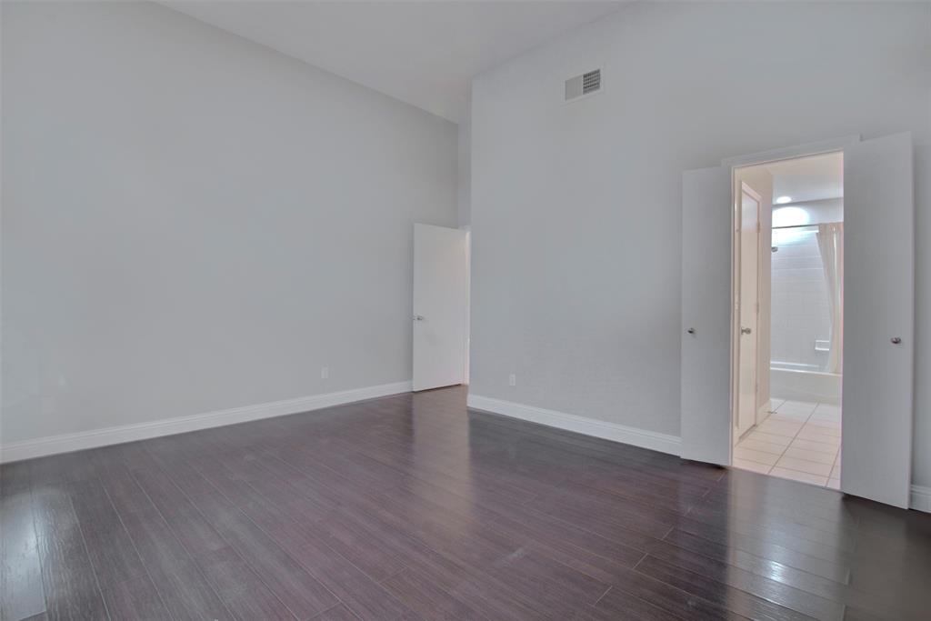 14822 Sopras Circle Addison, TX 75001 - Photo 16 of 33 a view of an empty room with wooden floor and a window