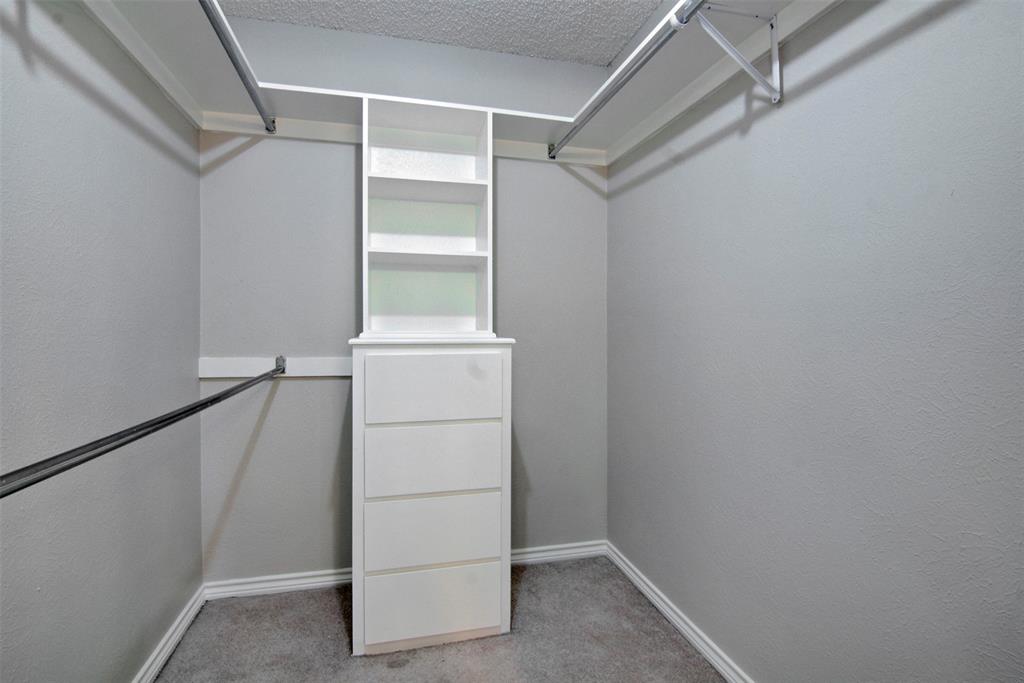 14822 Sopras Circle Addison, TX 75001 - Photo 18 of 33 a view of an empty walk in closet