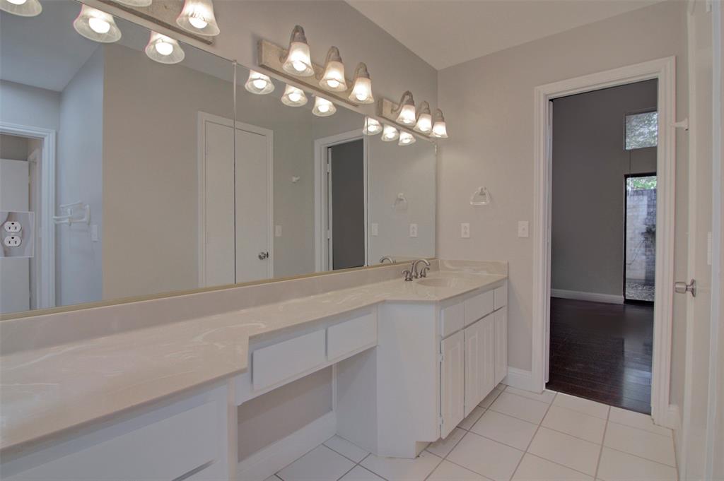 14822 Sopras Circle Addison, TX 75001 - Photo 19 of 33 a bathroom with a sink vanity and a mirror