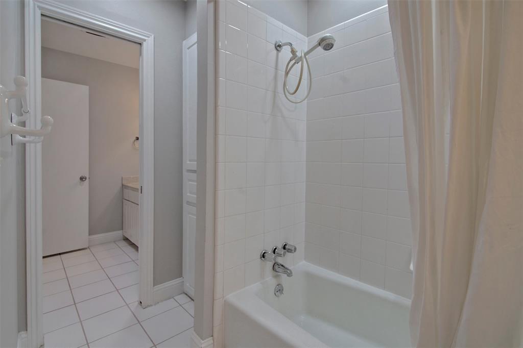 14822 Sopras Circle Addison, TX 75001 - Photo 20 of 33 a bathroom with a bathtub and a shower
