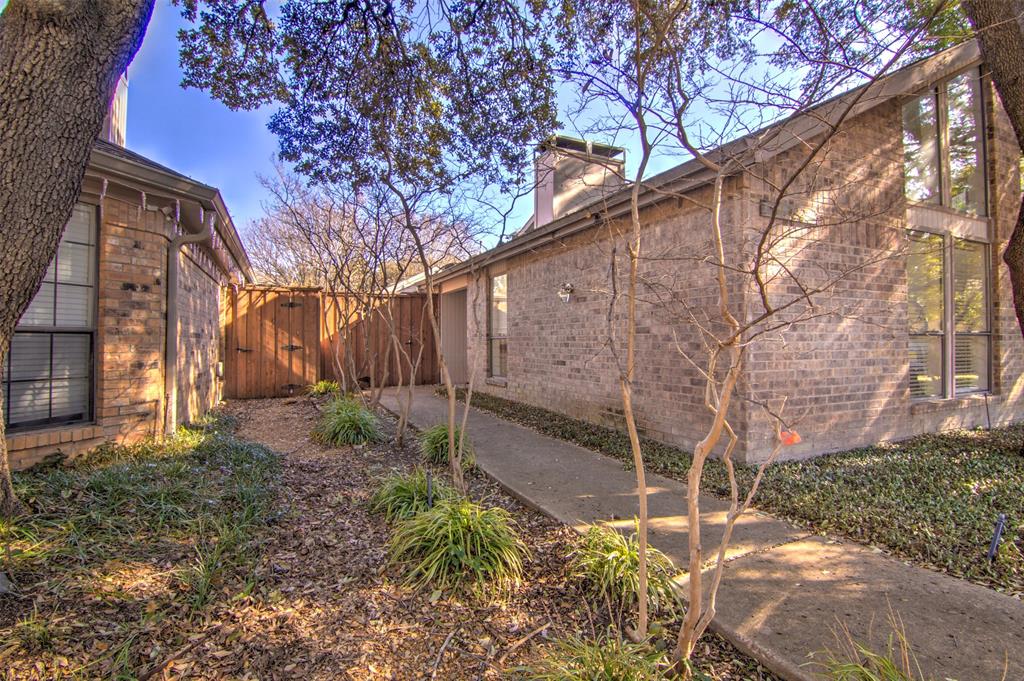 14822 Sopras Circle Addison, TX 75001 - Photo 2 of 33 a backyard of a house with lots of green space