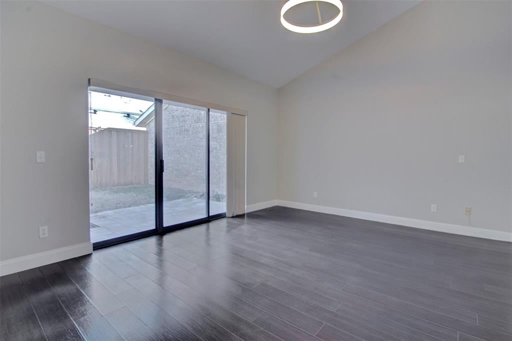 14822 Sopras Circle Addison, TX 75001 - Photo 23 of 33 a view of an empty room with wooden floor and a window