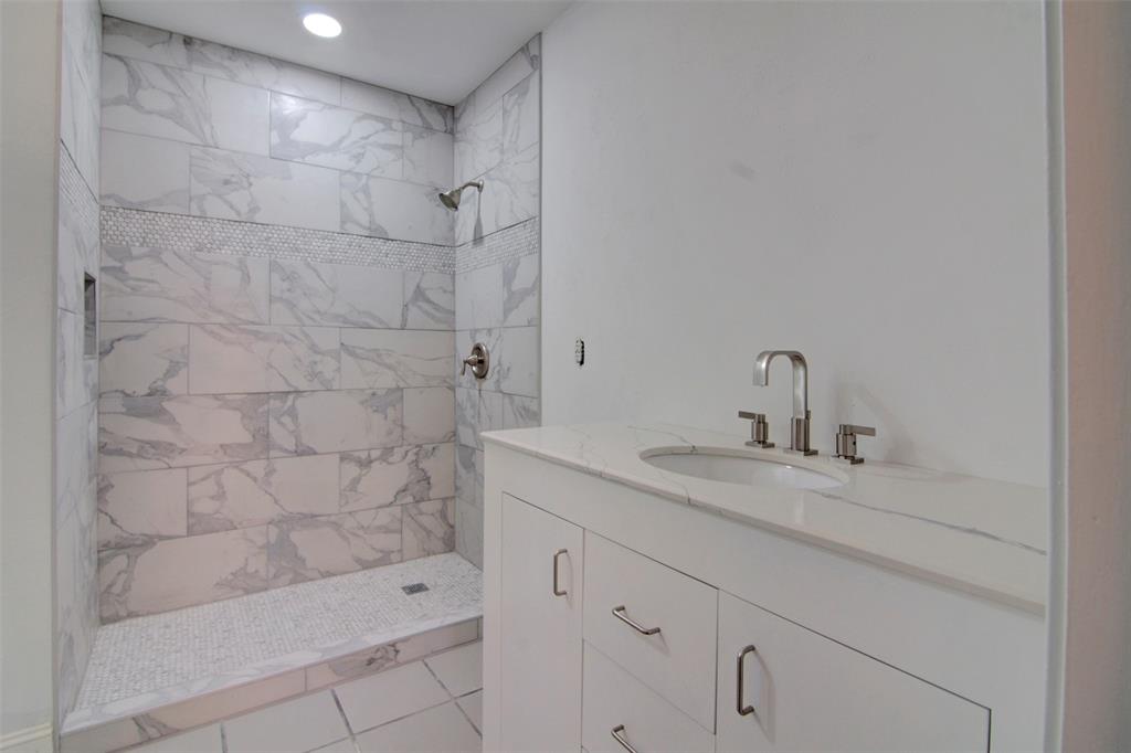 14822 Sopras Circle Addison, TX 75001 - Photo 25 of 33 a bathroom with a granite countertop sink a toilet and shower
