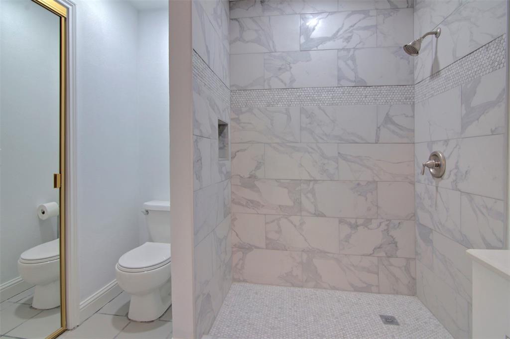 14822 Sopras Circle Addison, TX 75001 - Photo 26 of 33 a bathroom with a toilet and shower