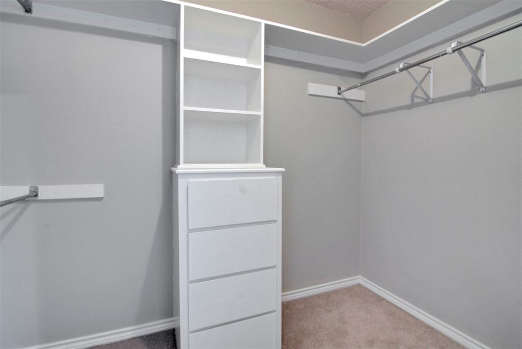 14822 Sopras Circle Addison, TX 75001 - Photo 27 of 33 a view of an empty walk in closet