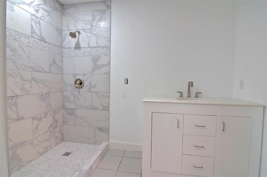 14822 Sopras Circle Addison, TX 75001 - Photo 28 of 33 a bathroom with a shower sink and mirror