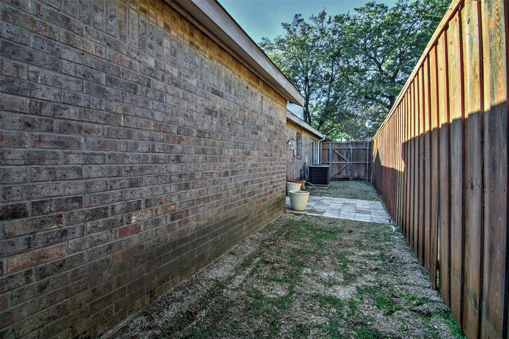 14822 Sopras Circle Addison, TX 75001 - Photo 33 of 33 a view of a pathway of a house with backyard and wooden fence